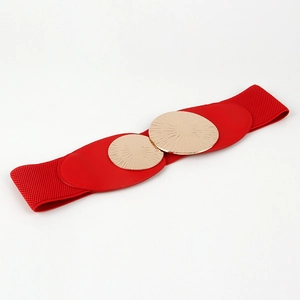 Detail of red elastic waist belt with textured gold circular metallic buckles