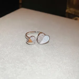 Polished silver butterfly ring featuring mother of pearl heart and zircon stones