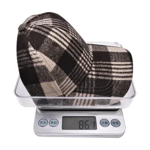 Detailed view of plaid wool baseball cap weighing 86.1g on a digital scale