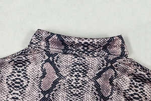 Detail of snake print fabric with reinforced stitching on a slim fit collar neck