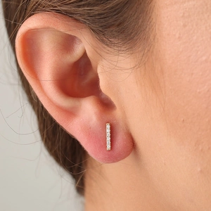 Minimalist gold bar stud earrings with S925 silver needle and cubic zirconia on model ear