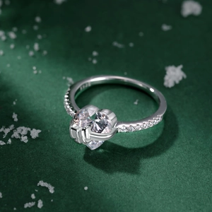Macro shot of S925 sterling silver heart ring with sparkling side stones and hallmark