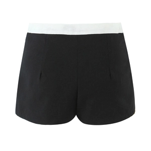 Detail of black shorts featuring a contrasting white waistband with premium stitching