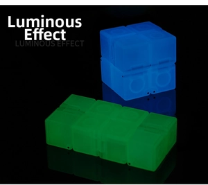 Close-up of luminous blue and green infinity cubes glowing in dark for stress relief