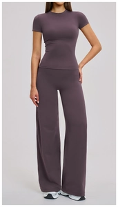 Detail of high-waisted wide-leg yoga pants and fitted t-shirt set in purple matte fabric