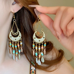 Bohemian gold crescent moon earrings with colorful bead tassels and white enamel drop
