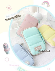 Close-up of quilted DuPont cotton pouches in pastel colors with woven logo labels