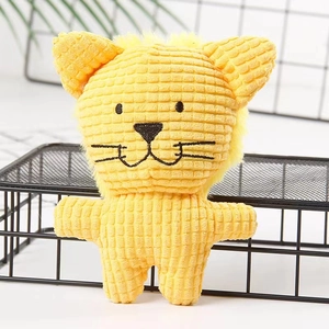 Detailed view of yellow lion plush dog toy with textured waffle fabric and embroidered face