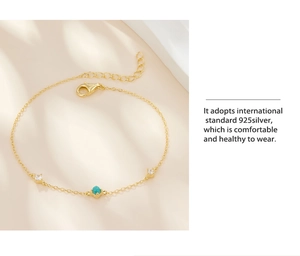 Detail of 925 silver gold-plated bracelet featuring turquoise and zircon accents