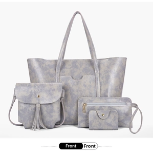 Front view of grey four-piece handbag set including tote, crossbody, wallet and card holder