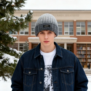 Mens winter ribbed knit beanie with fleece lining in grey outdoors with snowy background