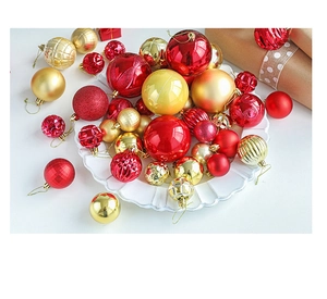 Detail view of red and gold Christmas ball ornaments with glitter and matte finishes