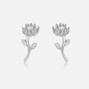 Detailed view of silver protea flower stud earrings with a brushed metal texture finish