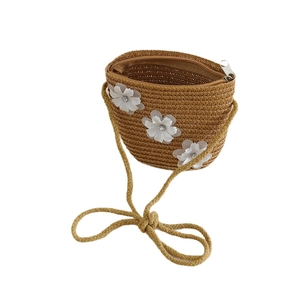 Handwoven straw shoulder bag with delicate white floral accents for toddlers