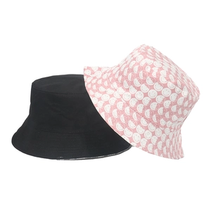 Reversible double-sided smiley face bucket hat in black and pink cotton for women