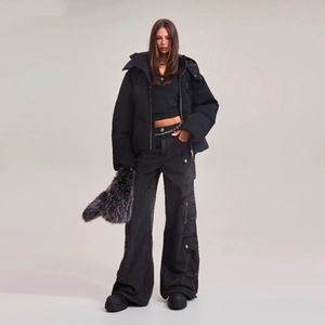 Close-up of black oversized puffer jacket and multi-pocket cargo pants streetwear look