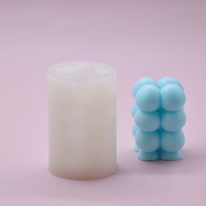Detail view of a white silicone mold and a finished sky blue bubble cube candle
