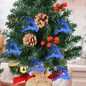Blue glitter reindeer ornaments hanging on a Christmas tree with pine cones and berries