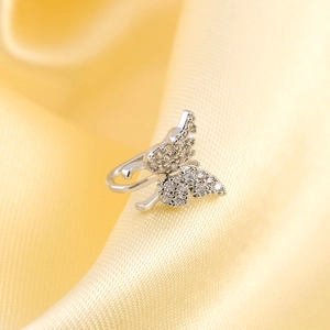 Detailed close-up of a silver butterfly ear cuff with sparkling zircon stones