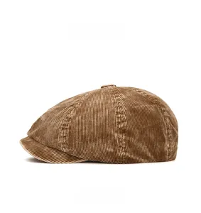 Side view of a vintage brown corduroy newsboy cap showing detailed ribbed texture and top button