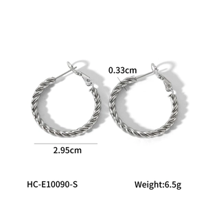 Macro view of silver twisted hoop earrings with 2.95cm diameter and 0.33cm width specs