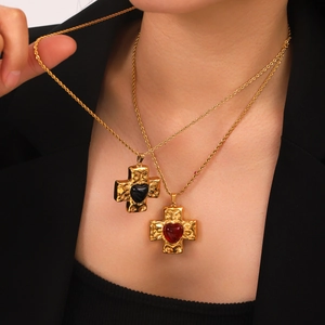 Gold stainless steel cross necklace with heart crystal pendant on male model