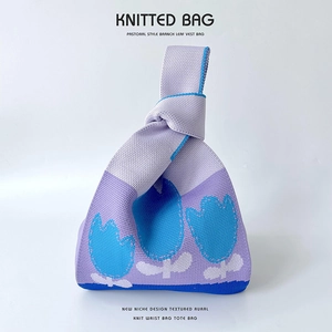 Detailed close-up of violet tulip knitted bucket bag texture and pastoral floral pattern