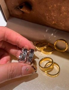Macro shot of 18k gold plated wrinkled texture rings on a jewelry display case