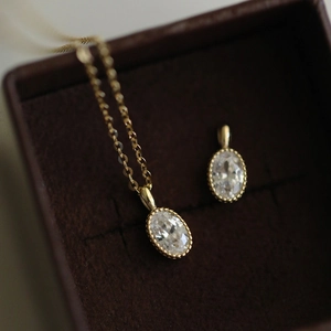 Macro view of vintage silver crystal pendant in a velvet box with intricate bead edges