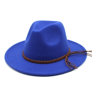 Close-up of royal blue wool fedora with brown braided band and tassel detail