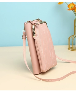 Detail of pink PU leather phone bag with leaf stitching and vintage metal kiss lock clasp