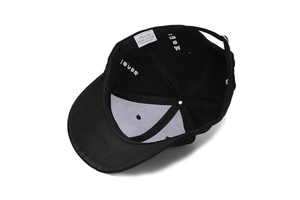 Detail view of cotton baseball cap interior showing stitching and brand wash label