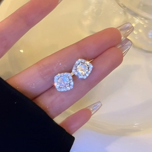 Sparkling silver square stud earrings with central cubic zirconia and halo diamond design
