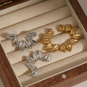 Polished stainless steel leaf-shaped hoop earrings in gold and silver finishes