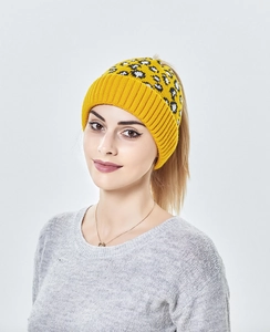 Détail du bonnet en tricot gingembre avec motif léopard noir et blanc et ouverture queue de cheval