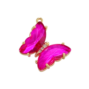 Detail of butterfly pendant with faceted rose red crystals and 18K gold plated base