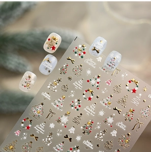 Detailed view of gold embossed Christmas nail stickers with tree and star patterns