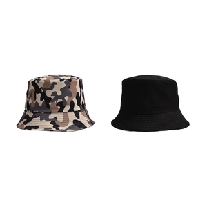Detail shot of camo and solid black cotton bucket hats with parallel brim stitching