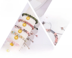 Detail of beaded natural stone bracelets with sunflower charms and adjustable buckles