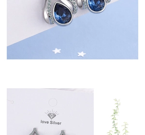 Macro view of blue water drop crystal earring with silver zircon details