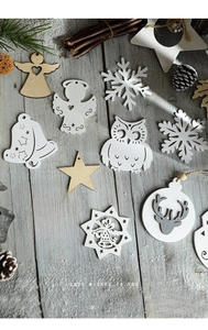Detail of Nordic wooden Christmas ornaments featuring stars and owl shapes on wood floor