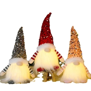 Three Christmas gnomes with LED lights and sequined hats in red, grey and orange colors