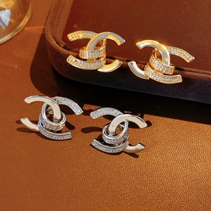 Detailed view of intertwined double C earrings with micro-pave cubic zirconia on leather