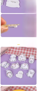 Detail view of acrylic puppy pins featuring laser-cut edges and white safety fasteners