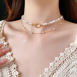 Double layer necklace with white pearls and yellow gemstone pendant on a gold chain