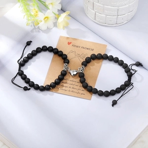 Close-up of magnetic heart clasp on couples bead bracelets with Pinky Promise card