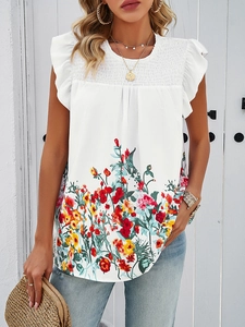 Detailed close-up of colorful floral print and ruffled sleeves on white summer top
