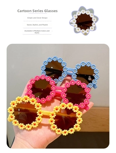 Detailed view of child's flower-shaped sunglasses in light blue, pink, and yellow colors