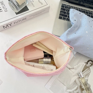 Detailed interior view of star sequin makeup bag showing large storage capacity and items