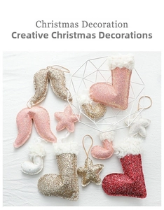 Glittery Christmas ornaments set featuring stars, socks and wings on a textured surface